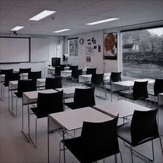 an empty classroom with desks and chairs