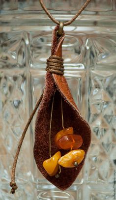 a glass jar filled with lots of different colored items hanging from it's side