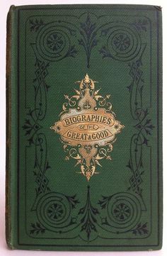 an old green book with gold lettering and ornate designs on the front, sitting on a white surface