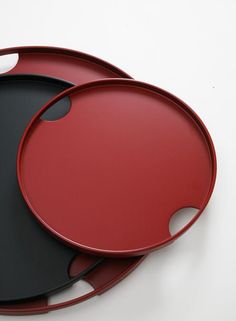 two black and red trays sitting on top of each other