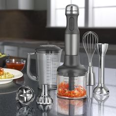 a blender sitting on top of a counter next to other kitchen appliances and utensils