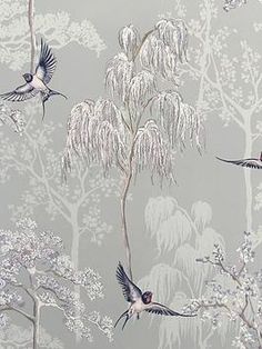 two birds are flying over the trees and flowers in this grey wallpaper design with white branches