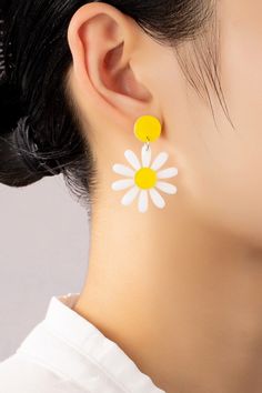 Daisy Drop Earrings: These lightweight acrylic daisy drop earrings make the perfect 90s throwback accessory! Made of white and yellow acrylic with push pack posts to keep them secure.Length: 1 inches x 1.5 inches White Flower-shaped Trendy Earrings, Trendy White Flower-shaped Earrings, Trendy Yellow Plastic Earrings, Trendy White Plastic Earrings, Trendy White Daisy Shaped Jewelry, Trendy White Daisy-shaped Jewelry, Trendy White Earrings, White Daisy Flower Earrings For Spring, Cute White Flower Earrings For Spring