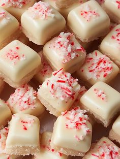 many pieces of white chocolate with red sprinkles