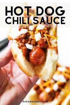 Hand holding a hot dog covered in chili sauce with chopped fresh onions over it. Hot Dogs Sauce, Chilidog Recipe, Game Appetizers, Homemade Hot Dog Chili