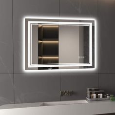 a bathroom sink with a lighted mirror above it