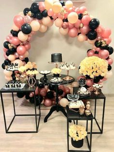 a table topped with lots of balloons and desserts