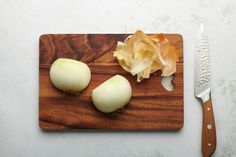 two onions and an onion on a cutting board with a knife