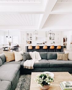 a living room filled with lots of furniture and decor on top of a wooden table