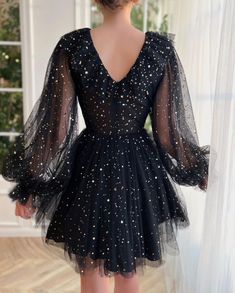 Immerse yourself in the vast midnight sky with this youthful mini dress. like the constellation "Irene" that is named after, the striking black fabric is embellished with starry sequins, combined with stunning matchmaking ruffles. Finally, Its lon... Moon Dress Black, Hoco Dresses Space Theme, Black Lantern Sleeve Cocktail Dress, Black Long Sleeve Mini Dress For Prom, Evening Mini Dress With Ruffles And Lantern Sleeves, Black Lantern Sleeve Party Dress, Black Lantern Sleeve Dress For Party, Winter Evening Mini Dress With Lantern Sleeves, Party Dress With Ruffles And Lantern Sleeves