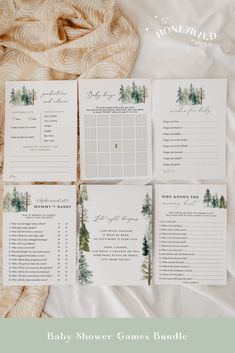 the baby shower games bundle is laid out on top of a white sheet with pine trees