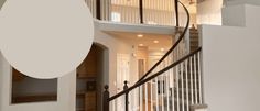 a staircase in a house with white walls and railings leading to the second floor