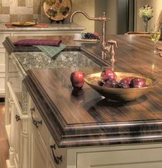 a bowl of fruit is sitting on the kitchen counter