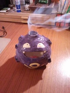 a purple ball sitting on top of a wooden table