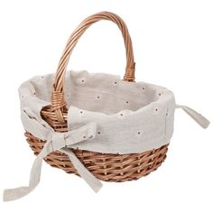 a wicker basket with a bow on the handle and white linen lining, isolated against a white background