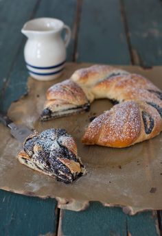 two pastries sitting on top of a wooden cutting board