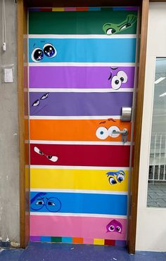 the door is decorated with different colored stripes and cartoon characters, including one eye on each side