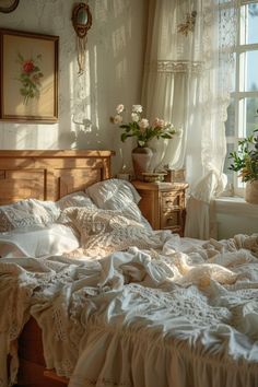 an unmade bed with white linens in a bedroom next to a large window