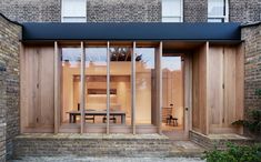 the outside of a brick building with glass doors