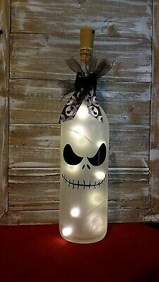 a lighted bottle with a skeleton face on the top and lights in the bottom for decoration