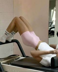 a man and woman are doing exercises on a treadmill