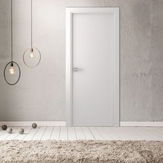 an empty room with a white door and some balls on the floor