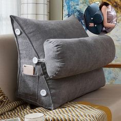 two gray pillows with buttons on them sitting next to a coffee cup and phone holder