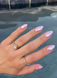 a woman's hand with pink and white manicured nails