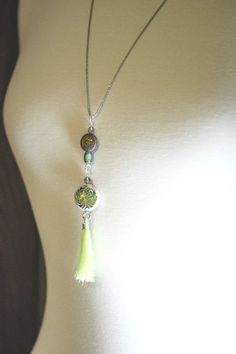 "Feel sassy with this fantastic lime tassel necklace accented by lovely mood beads to make your tassel necklace the most fabulous of them all  Gorgeous splashes of mood changing color and soothing patterns.  Dazzling diamond cut 28\" gunmetal plated ball chain.  Mood beads are created with thermo-sensitive liquid crystals that change color as skin temperature (mood) changes. You'll have so much fun watching the beads change from purple to yellow and every color in between! (See chart in the photo gallery for various mood color meanings) Please note: These beads and tassel should not be submerged in water. ☀ ☀ ☀ ☀ ☀ ☀ ☀ DESCRIPTION & FEATURES ☀ ☀ ☀ ☀ ☀ ☀ ☀ ☀ Thermo sensitive polymer mood beads. ☀ Silk tassel with silver trim. ☀ Swarovski antique pink faceted crystals. ☀ Diamond cut antique Mood Colors, Mood Changes, Color Meanings, Pocket Watch Chain, Antique Pink, Pen Gift, Watch Chain, Necklace Long, Beaded Tassels