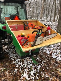 a tractor trailer filled with tools in the woods