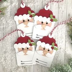 three christmas tags with santa's face on them