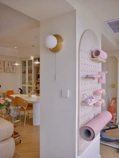 a living room filled with furniture and lots of shelves on the wall next to a table