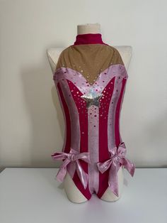 a mannequin wearing a pink and brown corset with sequins