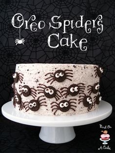 a cake with spider decorations on it and the caption reads oreo spider cake