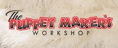 the puppet maker's workshop logo on a furry white background with red and black lettering