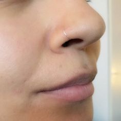 a close up of a person with nose piercings