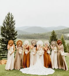 a group of women standing next to each other on top of a lush green field