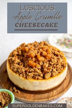 an apple crumble cheesecake on a wooden platter with the title above it