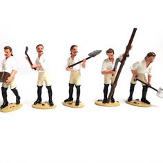 several figurines of men holding tools and standing in different positions on white background