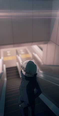 a person standing in front of an escalator with their back to the camera