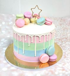 a colorful cake with macaroons and stars on top