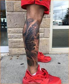 a man's leg with a dragon tattoo on it and his red nike sneakers