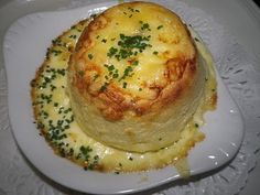 a plate with some food on it and garnished in parmesan cheese