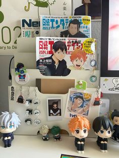 some anime figurines are sitting on a desk