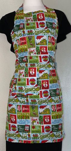 a woman's apron made out of coca - cola cans and other items on display