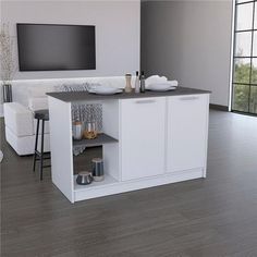 a living room with white furniture and a flat screen tv mounted above the entertainment center