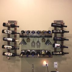 a wall mounted wine rack filled with bottles