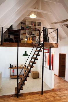 an open loft with stairs leading up to the second floor