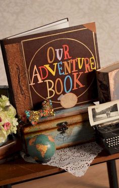 a book sitting on top of a table next to a typewriter