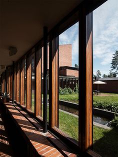 the sun shines through large windows onto a grassy area